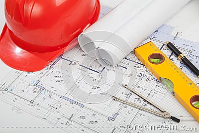 Red helmet, construction drafts and tools Stock Photo