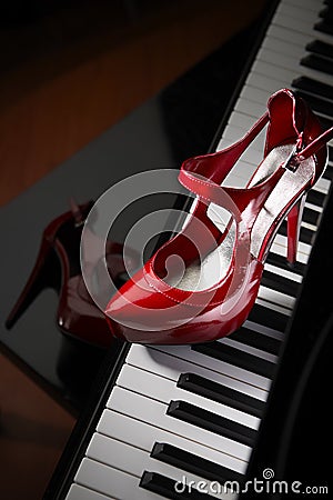 Red high heel shoes on piano Stock Photo