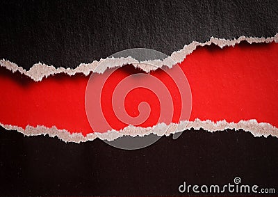 Red hole with torn edges in black paper Stock Photo