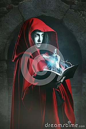 Red hooded woman casting powerful magic Stock Photo