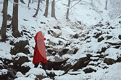 Red hooded woman in a snowy forest Stock Photo