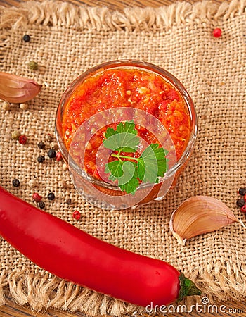 Red hot chili pepper and sauce on glass bowl Stock Photo