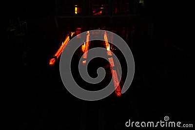 Red hot steel metal billets after molten steel casting. Background of the blacksmith and metallurgical industry Stock Photo