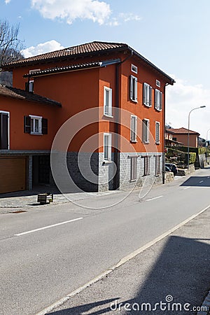 Red house exteriors on the road Stock Photo