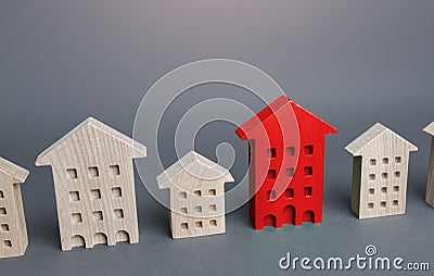 Red house among other buildings. Disconnection from utilities and communications, debts, emergency. Unsuitable for habitation Stock Photo