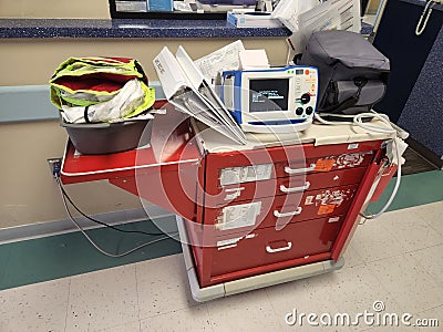 Red ICU Crash Cart with Defibrillator in Hallway Stock Photo