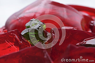 Red jello temptation and green pieces Stock Photo