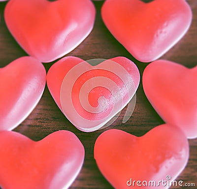 Red jelly hearts on wooden background Stock Photo