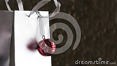 Red jingle bell on silver shopping bag Stock Photo