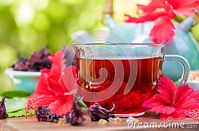 Red karkade hibiscus red sorrel tea in glass mug roselle flowers Stock Photo