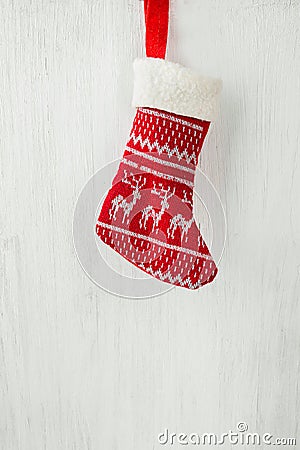 Red Knitted Christmas Stocking Hanging on White Wood Barn Board Fire Place. Scandinavian Ornaments. Festive Bright Cozy Atmosphere Stock Photo