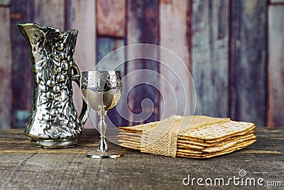 Red kosher wine with a white plate of matzah or matza and a Passover Haggadah Stock Photo