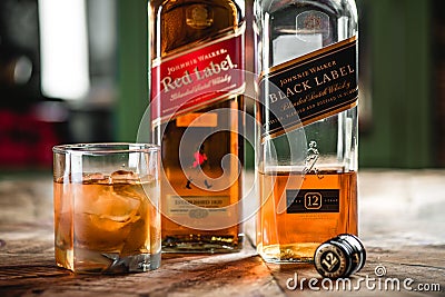 Red label and Black label whiskey bottles and glass with ice cub Editorial Stock Photo