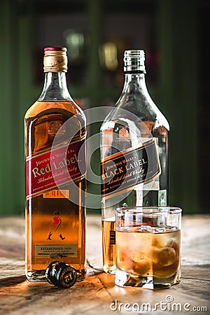 Red label and Black label whiskey bottles and glass with ice cub Editorial Stock Photo