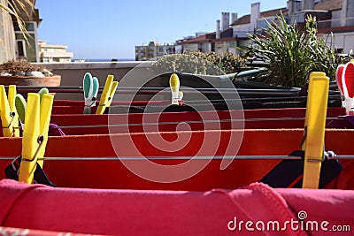 Red Laundry Drying, Colorful Pins, Home Plants, Balcony Stock Photo