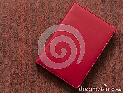 red leather notebook over wood background Stock Photo
