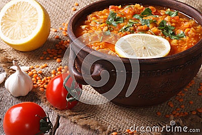 Red lentil soup with vegetables close-up on the table. horizontal Stock Photo