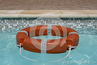 Red life buoy floating in swimming pool Stock Photo