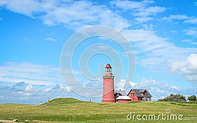 Red Lighthouse Bovbjerg Fyr with green grass and blue sky Stock Photo