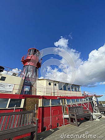 Red Lighthouse mounted atop a ship Stock Photo