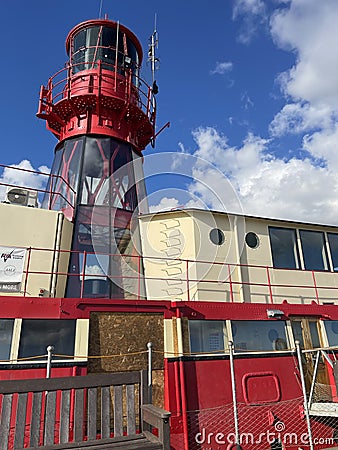 Red Lighthouse mounted atop a ship Stock Photo