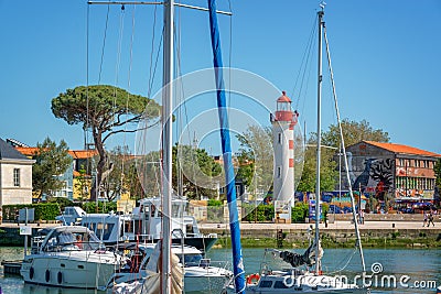 Red lighthouse and sailboats in the old harbor of La rochelle France Editorial Stock Photo