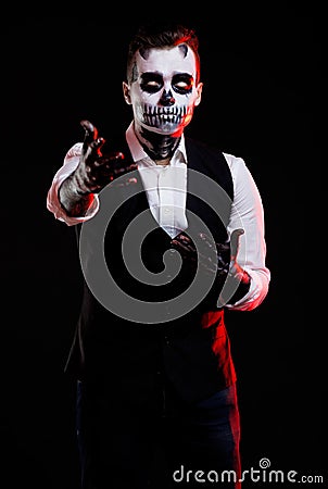 Red lights on man with creative make-up for the Halloween party. Stock Photo