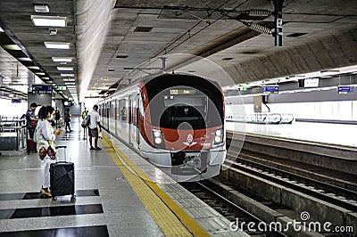 The Red Line train is docking at the platform at Bang Sue Station to Rangsit Station. Pathum Thani, Thailand Editorial Stock Photo