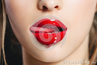 Red lip gloss. Closeup mouth with tongue. Saturated color Stock Photo