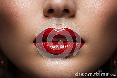 Red Lips Close up. Woman Beauty Face Make up. Glossy Shiny Lipstick Cosmetic. Model with Plump Lips Sexy Mouth Stock Photo