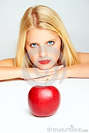 Red lips and a red apple Stock Photo