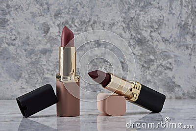 Red lipstick with black and pink on a marble surface Stock Photo