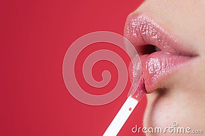 Red lipstick. Glossy make-up for plump natural lips. Lipstick and pomade. Close up red lips. Pink lipstick. Pomade Stock Photo