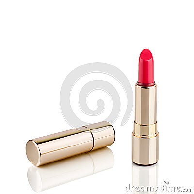 Red lipstick in golden tube on white background with mirror reflection on glass surface isolated close up, shiny gold lipstick Stock Photo