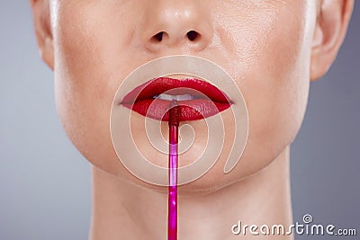 Red lipstick, lips and woman isolated on a studio background for makeup or product promotion. Model face with mouth Stock Photo