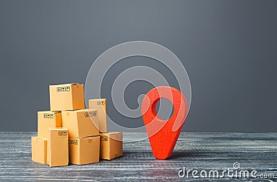 Red location pointer geolocation symbol and cardboard boxes. Distribution delivery of goods, freight transportation shipment. Stock Photo