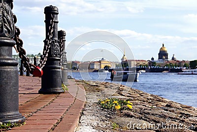 The red lock on the chain. The Neva embankment. Boats on the river Stock Photo