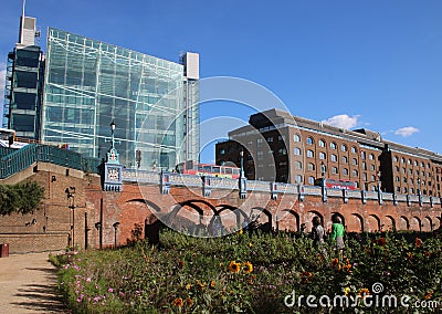 Red London Buses from Superbloom, Tower of London moat Editorial Stock Photo