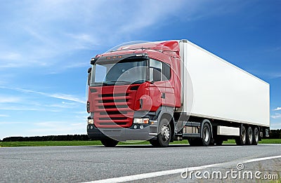 Red lorry with white trailer over blue sky Stock Photo