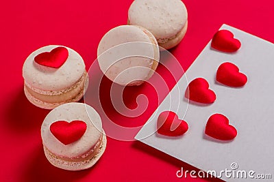 Red Macarons and red shaped hearts Stock Photo
