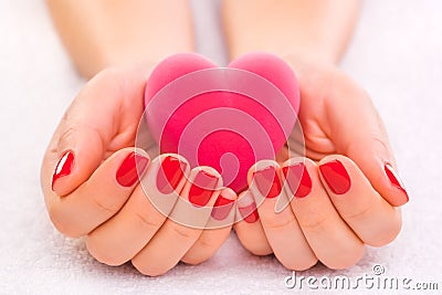 Red manicure with gift box on the white towel Stock Photo