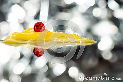 Red medical capsule on yellow ointment among bokeh Stock Photo