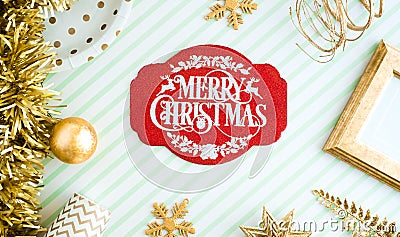 REd Merry christmas lable background.top view of sparkling gold tinsel,ball,ornament decorate on green strip line table.holiday Stock Photo