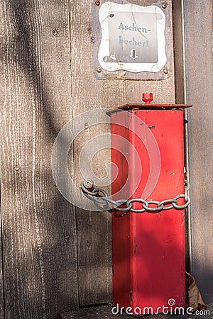 Red metal ashtray outdoors Stock Photo