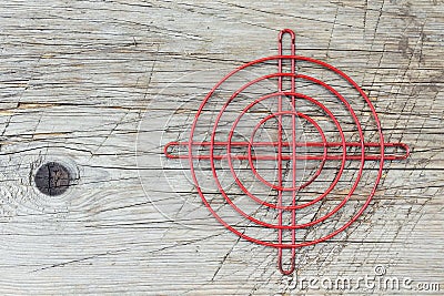 Red metallic crosshair on an old wooden surface Stock Photo