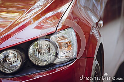 Red modern car, close-up. Headlights of the car Stock Photo