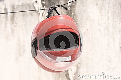 Red motorcycle helmet hanging on the clothes line Stock Photo