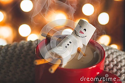 Red mug with hot chocolate with melted marshmallow snowman Stock Photo