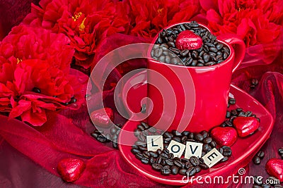 Red mug with LOVE letters rosted coffee beans sexy red background Stock Photo