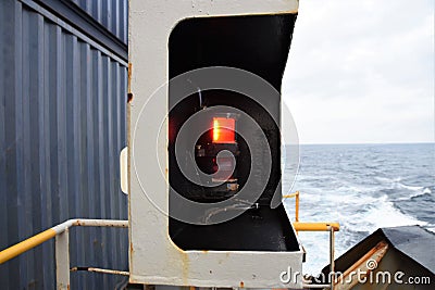 Red navigational light on the port side of the vessel Stock Photo